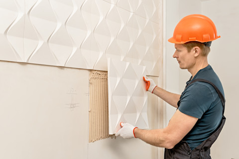 Wooden wall panels are being installed.