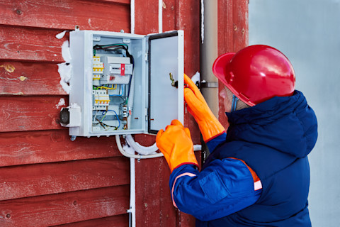 Electrician checking faulty meter