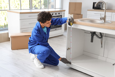 A kitchen fitter is installing a new kitchen
