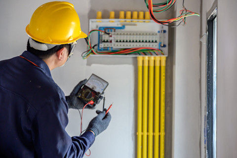 Electrician looking at electrical board