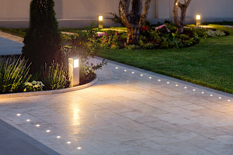 This image shows a close up of a tiled path in a manicured garden