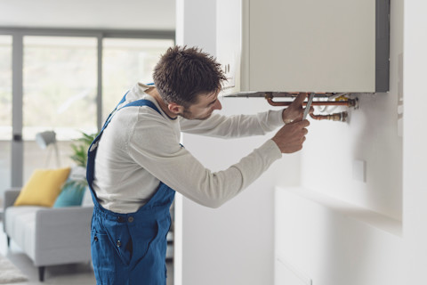 Handyman replacing a boiler