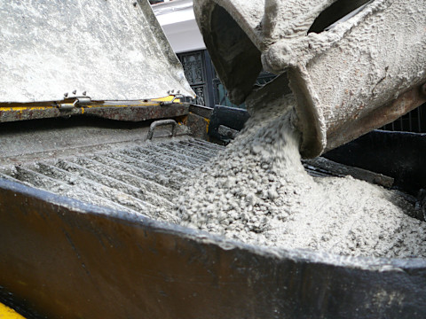 This image shows concrete being poured out of a chute.