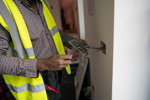 An electrician installing a smart plug.