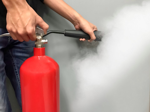 Person using a fire extinguisher