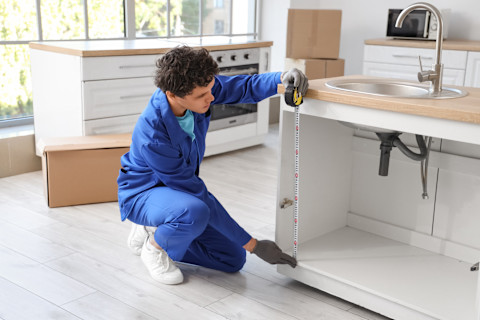 A kitchen fitter is installing a new kitchen
