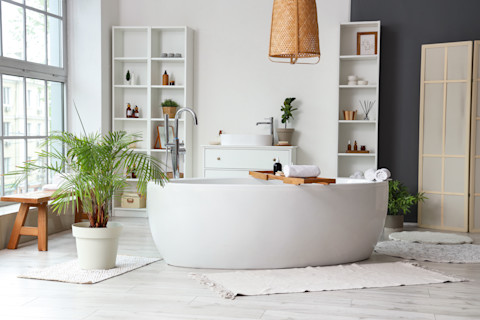Stylish bathroom with bathtub, shelving unit and window