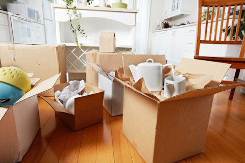 House with items packed in cardboard boxes