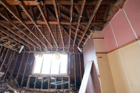 Building work underway in a suburban Edwardian house in Pinner, northwest London UK. The builder is taking the house back to brick exposing the original lath and plaster infrastructure.