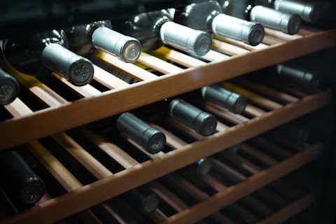 A wine rack in the dark.