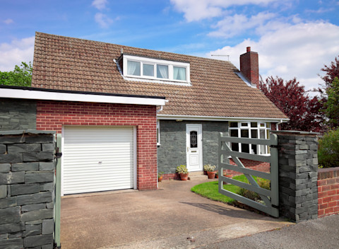 A detached garage attached to a house