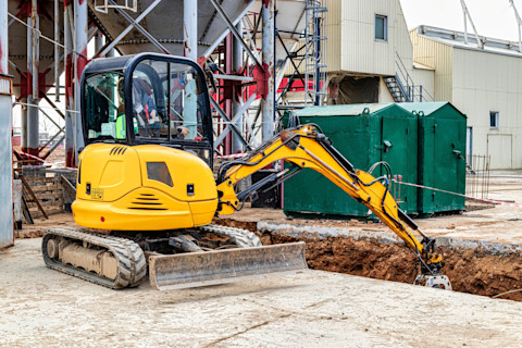 Excavator digging a trench
