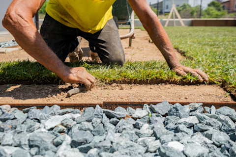 A landscaper is renovating a garden.