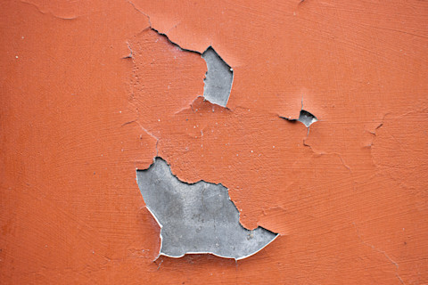 Cracked paint on a wall and ceiling