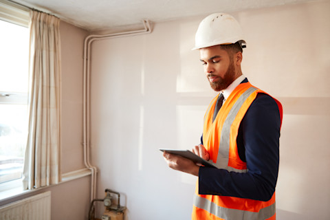Contractor surveying a room of a house
